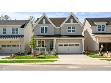 Charming two-story home with a welcoming front porch and well-manicured lawn at 1733 Birdhaven Ln # 2217, Wendell, NC 27591