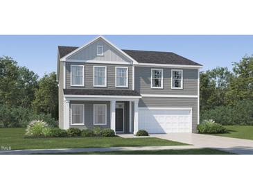 Charming two-story home with gray siding, white trim, a well-manicured lawn, and an attached two-car garage at 4017 Shadbush St, Raleigh, NC 27616