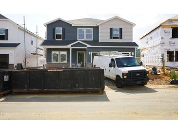 New construction home with mixed siding; construction van parked in front at 659 White Birch Ln, Angier, NC 27501