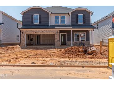 Two-story home with a two-car garage and brick and siding details at 741 Deschutes Dr, Garner, NC 27529