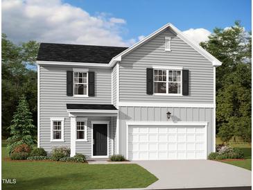 Charming two-story home with gray siding, black shutters, a well-manicured lawn, and an attached two-car garage at 914 Bombardier Aly, Spring Hope, NC 27882