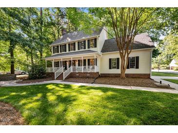 Charming two-story home with a large, inviting front porch and beautiful landscaping at 1005 Stuart Dr, Mebane, NC 27302