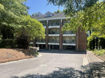 Attractive multi-story condo building with brick accents and convenient covered parking at 113 Conner Dr # 203, Chapel Hill, NC 27514