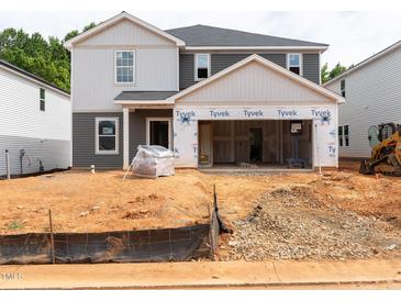 Two-story home exterior showcasing gray and white siding, attached two-car garage, and construction in progress at 1139 Winding Spring Dr, Mebane, NC 27302