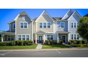 Charming townhomes with varied color schemes, tidy lawns, and well-maintained landscaping in a pleasant neighborhood setting at 124 Shale Creek Dr, Durham, NC 27703