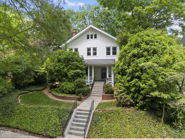 Charming two-story home with a landscaped yard and inviting front porch with brick accent at 223 Hawthorne Rd, Raleigh, NC 27605