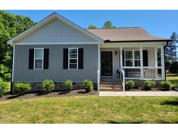 Charming single-story home with well-maintained landscaping and a welcoming front porch at 236 Bragg Ln, Hurdle Mills, NC 27541