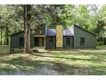 Charming olive green home with a unique wooden chimney accent and inviting walkway at 434 Robin Rd, Chapel Hill, NC 27516