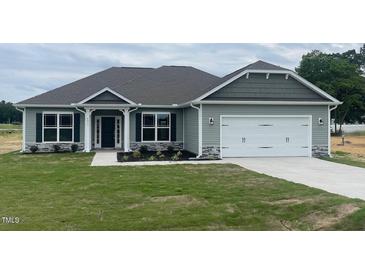 Charming one-story home featuring a two-car garage, well-manicured lawn and stone accents at 473 Sweet Potato Lane # 12, Nashville, NC 27856