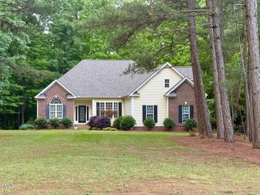 Charming ranch home with brick accents, black shutters, and a well-manicured lawn at 6673 Nc 96 W Hwy, Youngsville, NC 27596