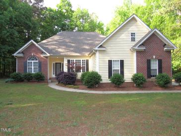 Charming one-story home with brick and vinyl siding and manicured front yard at 6673 Nc 96 W Hwy, Youngsville, NC 27596