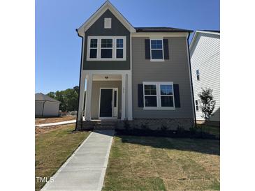 Charming new construction home with a two-tone exterior and inviting covered front porch at 773 Portland Rose Dr, Knightdale, NC 27545