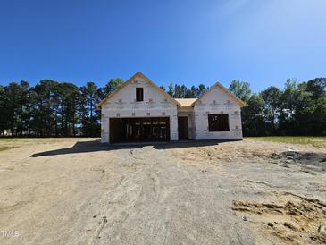 Exterior of home under construction with a garage and a blue sky above at 79 Mildred Dr, Broadway, NC 27505