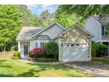 Charming home featuring a well-manicured lawn and an attached two-car garage at 8437 Whisper Ridge Pl, Raleigh, NC 27613