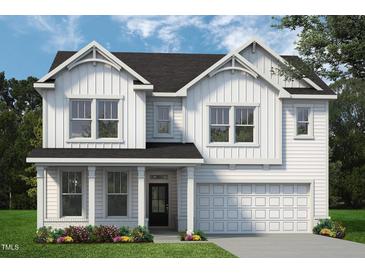 Charming two-story home featuring white siding, a covered porch, and an attached two-car garage at 1038 Beacon Hill Rd # 46, Lillington, NC 27546