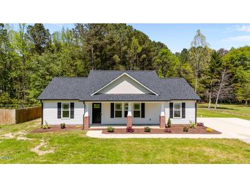 Charming single-story home featuring a landscaped front yard and classic architectural details at 1914 Jack Rd, Clayton, NC 27520