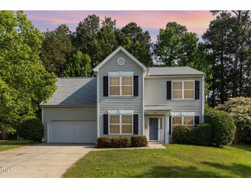 Charming two-story home with a well-manicured lawn and attached garage at 203 Downing Bluff Dr, Morrisville, NC 27560