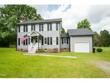 Charming two-story home with gray siding, black shutters, and a well-manicured lawn at 3004 Red Cir, Willow Springs, NC 27592