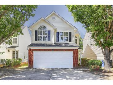 Charming two-story home with a brick accented garage and well-maintained landscaping at 5456 Grand Traverse Dr, Raleigh, NC 27604