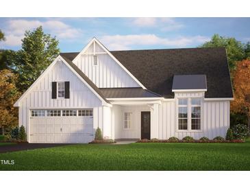 Charming exterior elevation of a white farmhouse-style home with a two-car garage and beautiful landscaping at 63 W Victoria Ridge Dr # 31, Selma, NC 27576