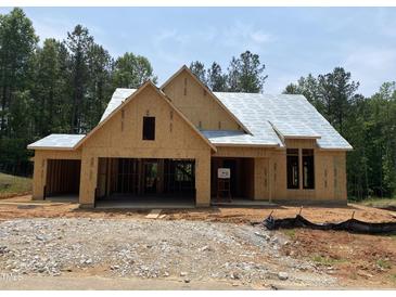 Unfinished exterior of a single-story home with a two-car garage and a gabled roof under construction at 63 W Victoria Ridge Dr # 31, Selma, NC 27576