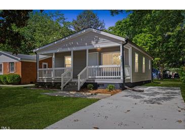 Charming gray home with a welcoming front porch and well-maintained lawn at 806 Martin Luther King Jr Dr, Smithfield, NC 27577