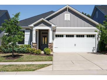Charming gray house with a two-car garage and manicured landscaping, creating excellent curb appeal at 816 Still Willow Ln, Wendell, NC 27591