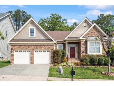 Charming single-story home featuring a two-car garage, brick facade, and inviting front garden at 913 S South Bend Dr, Durham, NC 27713