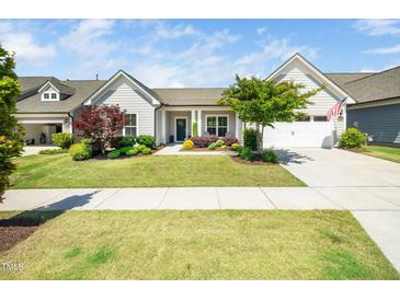 Charming single story home with a well manicured lawn and beautiful landscaping at 1121 Coast Grade St, Wake Forest, NC 27587