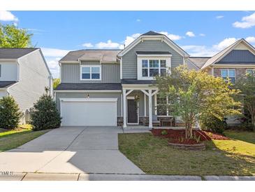 Inviting two-story home featuring a two-car garage, covered porch, and charming curb appeal at 114 Red Robin Rd, Durham, NC 27703