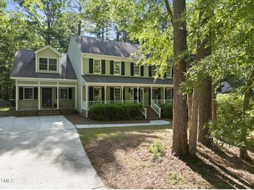 Charming two-story home with a welcoming front porch and lush greenery at 128 Cobblestone Dr, Chapel Hill, NC 27516
