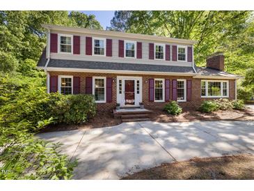 Traditional two-story brick home featuring red shutters and a well-manicured front yard at 1506 Ephesus Church Rd, Chapel Hill, NC 27517