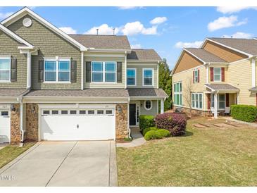 Two-story home with a two-car garage, beautiful stone accents, and well-maintained landscaping at 201 Mayfield Dr, Apex, NC 27539