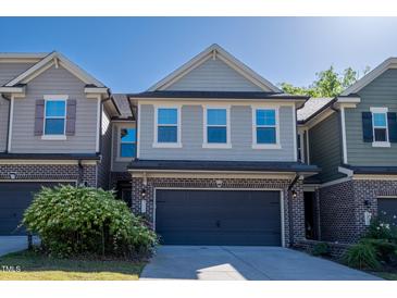 Charming two-story home with a two-car garage and attractive brick and siding exterior at 311 Alamosa Pl, Cary, NC 27519