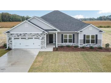 Charming single-story home featuring stone accents and a well-manicured lawn at 600 Sweet Potato Lane # 38, Nashville, NC 27856