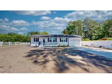 Charming, renovated ranch home featuring a fresh white paint job and new landscaping at 6715 Princeton Kenly Rd, Princeton, NC 27569