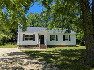 Charming single-story home featuring a white exterior, black shutters, and a well-maintained front yard at 710 E Azalea Ct, Fuquay Varina, NC 27526