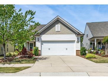 Charming home featuring a two-car garage, beautiful landscaping, and inviting curb appeal at 112 Manning Way, Durham, NC 27703