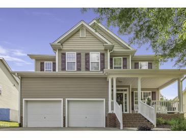 Charming two-story home with a welcoming front porch, attached two-car garage, and traditional siding details at 133 Pasadena Rd, Garner, NC 27529