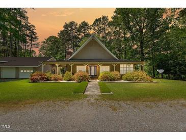Charming single-story home featuring a welcoming front porch and well-maintained landscaping at 1414 Walter Bright Rd, Sanford, NC 27330