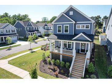 Charming two-story home with a welcoming front porch and beautifully landscaped yard in a desirable neighborhood at 201 Annabelle Blue Drive, Wake Forest, NC 27587