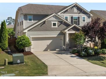 Charming two-story home with a two-car garage, landscaped front yard, and traditional design elements at 212 Crisp Rd, Durham, NC 27713