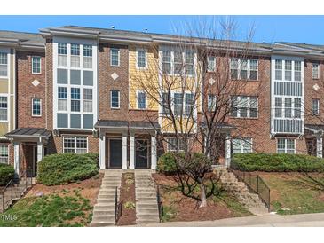 Charming multi-story townhomes with well-maintained landscaping and inviting front entrances at 235 Michigan Ave, Cary, NC 27519