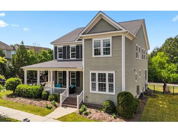 Charming two-story home with a welcoming front porch and well-maintained landscaping at 508 Vervain Way, Holly Springs, NC 27540