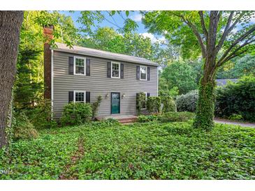 Charming two-story home featuring a brick chimney and well-maintained landscaping at 5212 Badham Pl, Raleigh, NC 27609