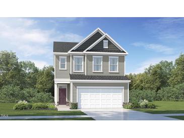 Charming two-story home with a classic design and manicured lawn and a two car garage at 545 Morning Light Dr, Angier, NC 27501