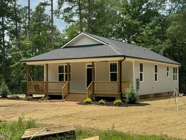 Charming single-story home with a welcoming front porch and light gray siding at 604 Natchez Trace, Fuquay Varina, NC 27526