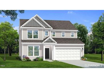 Charming two-story home with covered entrance, attached two-car garage, and beautifully landscaped front yard at 776 Old Station Pointe, Angier, NC 27501