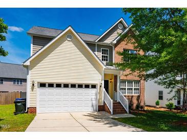 Charming two-story home with a mix of brick and siding, complemented by an attached two-car garage and a well-maintained lawn at 11 Piccadilly Ct, Durham, NC 27713