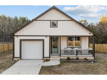 Charming craftsman-style home with a covered front porch and a one-car garage, set on a well-manicured lawn at 1101 Ridge Rd, Roxboro, NC 27573